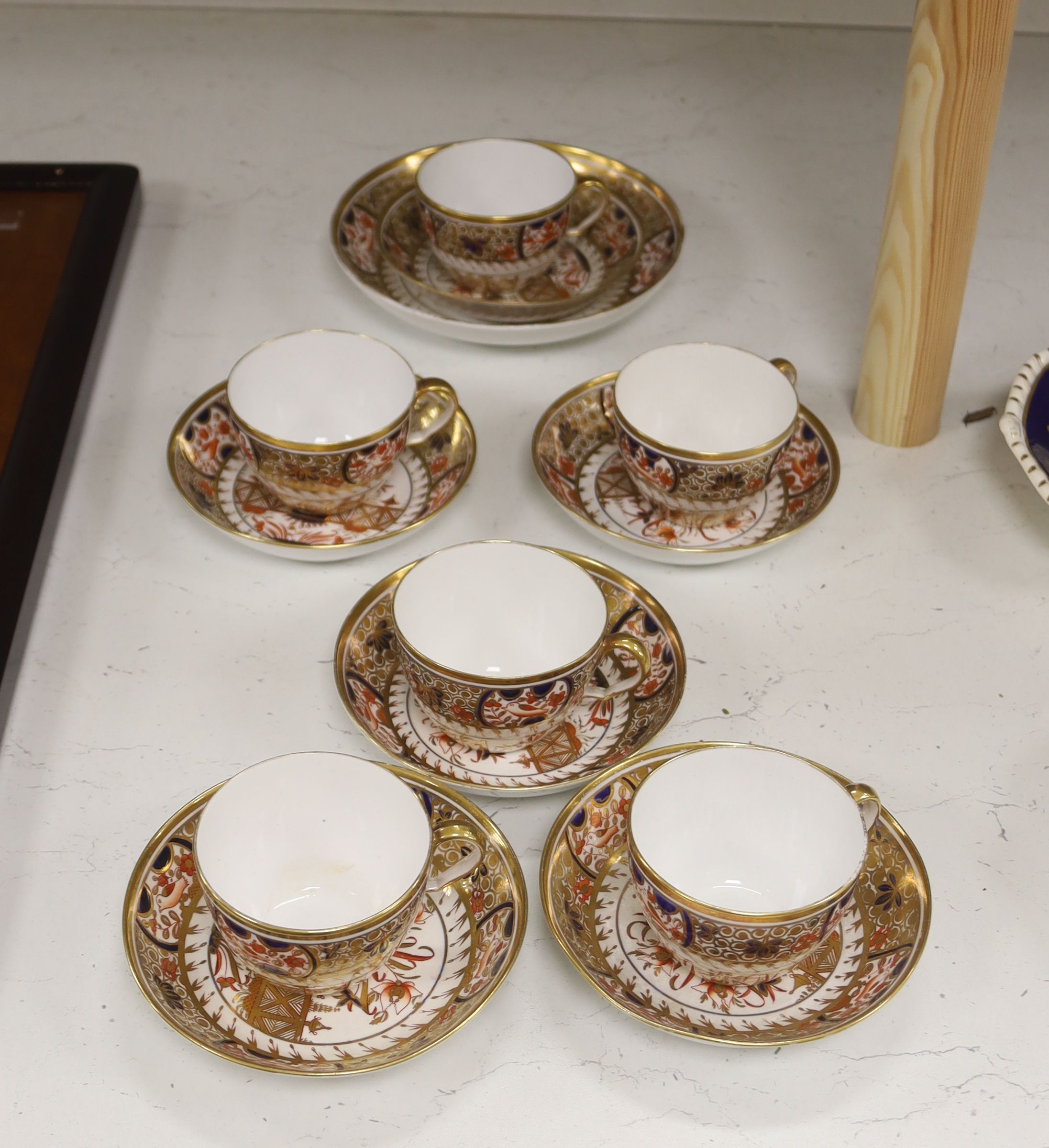 A set of six Spode teacups and saucers and a saucer dish painted with Imari pattern, amrked SPODE 1495